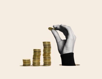 A,Hand,Makes,Stacks,Of,Coins.,Art,Collage.